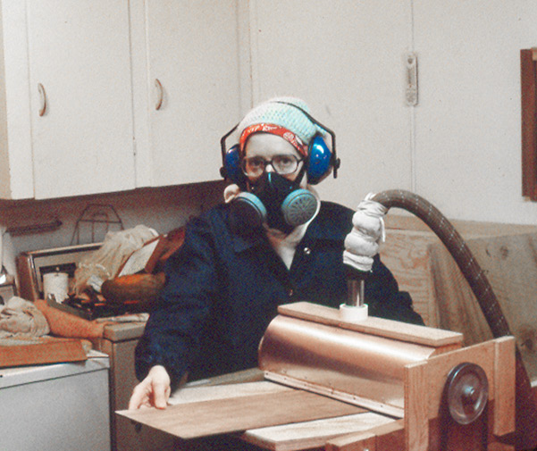 Peggy posing with her Brune sander back in the day. In actual use she would be standing in front of the machine with her back mostly toward the viewer, pushing the wood under the drum. It might help to have another person finish pulling the wood through the sander if no sled is used. All photos courtesy of Peggy Stuart.