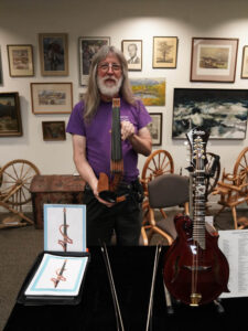 John Jordan shows off one of his amazing electric violins. (Stone)