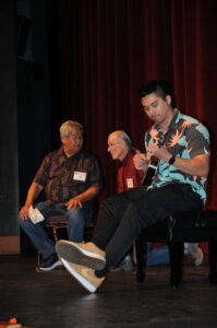 Moderator Nathan Ching consults with Todd Brotherton at the ukulele listening session as Travis Stein warms up. (Newsom)