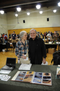 Partners in lutherie and life, Cyndy Burton and Jeff Elliott, at Jeff's exhibit. (Newsom)