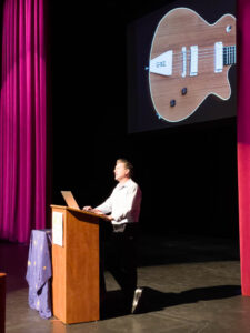 Electric guitar maker Barry Grzebik at the lecturn. (McElrath)