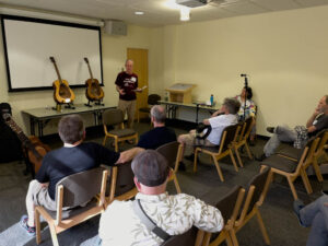 Reyn Vayda talks about his Turbo Guitars in the "Freedom Room," which was available to members to give ad hoc talks. (McElrath)