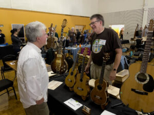 Bill Ellis visits with Rob McAllister at his exhibit table. (McElrath)