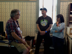Staffer Dale talks with Chuck and Marissa Tweedy in the Guild office. (McElrath)