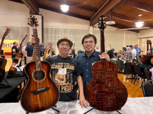 Jeffrey Yong and Jonathan Woo with Jeffrey's guitars, including his scrap wood guitar. (Woo)