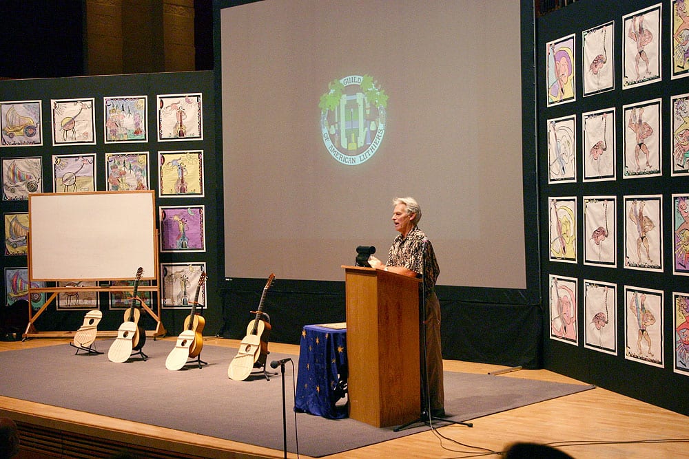 Here's Kenny Hill speaking to the 2004 GAL convention. On the stage are four of the guitar models he currently builds.
