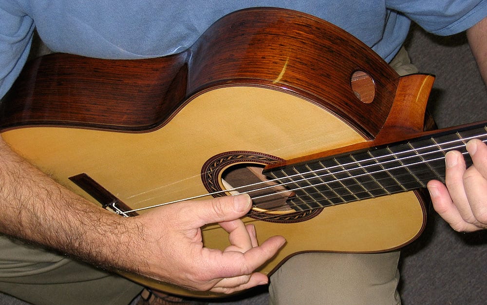 A Hill signature model. Note the soundports. Kenny works on a flamenco guitar in the style of Manuel Reyes based on GAL Instrument Plan #53. (image 1 of 2)