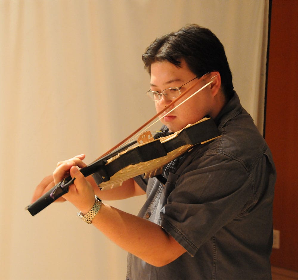 Marshall plays Doug Martin’s balsa fiddle.
