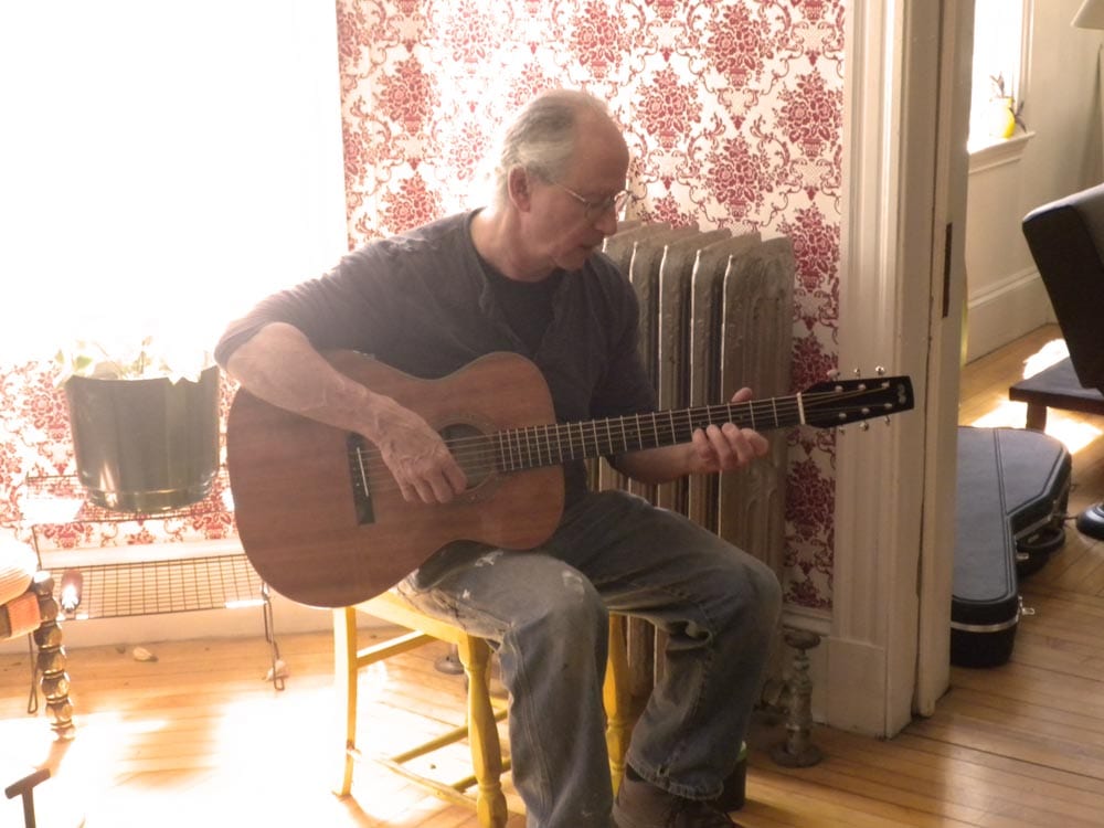 Paul Buck plays a guitar by Mike Mahar.