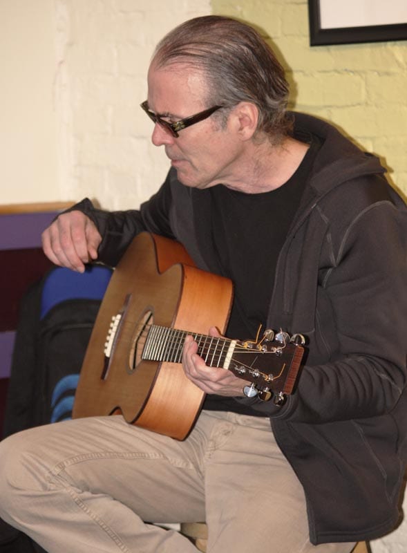 Jim Kelly plays a guitar by Tom Knatt.