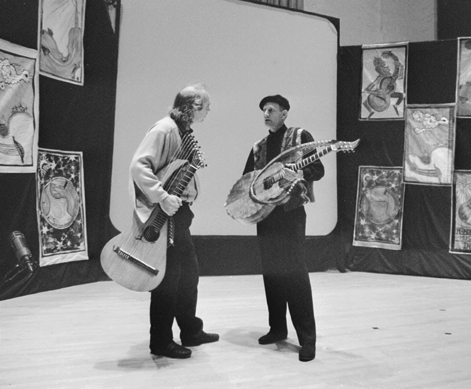 Harp guitars at the 1998 GAL Convention. Left: John Doan with Sullivan-Elliott instrument. Right: William Eaton with a harp guitar that he designed and built.