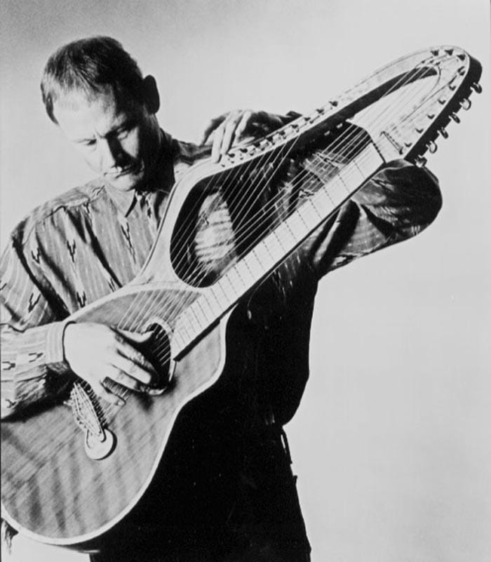 Eaton with another early harp guitar.