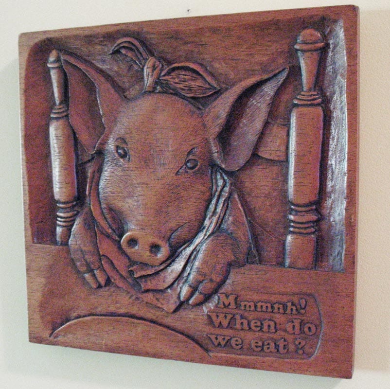 Carved from inch-thick mahogany, this plaque by Wade hangs in Everett’s kitchen.