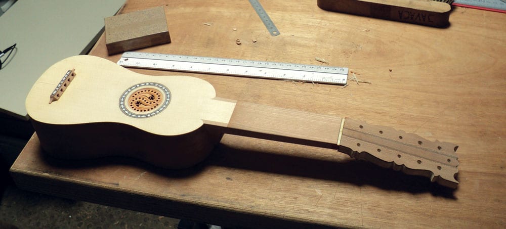 The smaller guitar before the moustaches were applied.