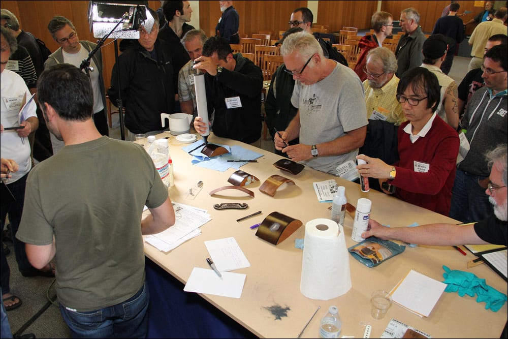 Convention attendees try out the materials and make notes following the guitar repair workshop by Brian Michael and Alex Glasser (Image 2 of 4).