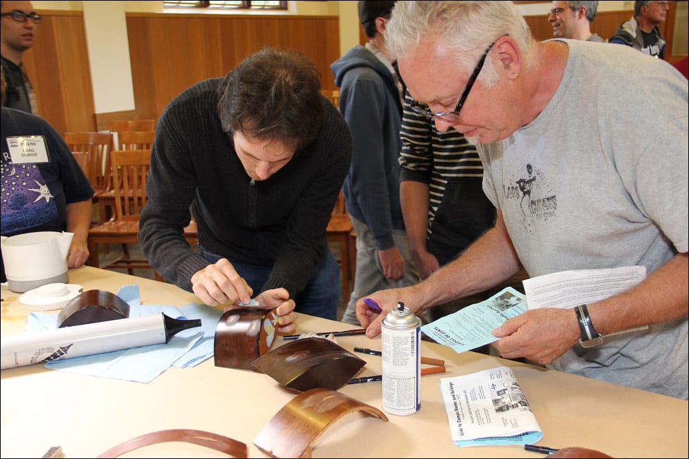 Convention attendees try out the materials and make notes following the guitar repair workshop by Brian Michael and Alex Glasser (Image 3 of 4).