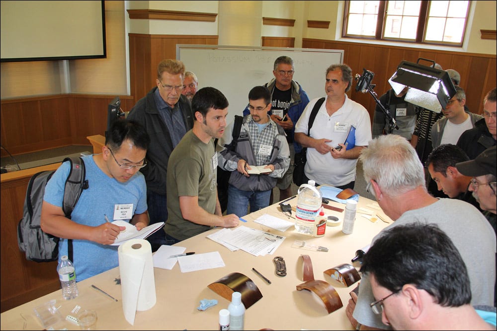 Convention attendees try out the materials and make notes following the guitar repair workshop by Brian Michael and Alex Glasser (Image 4 of 4).