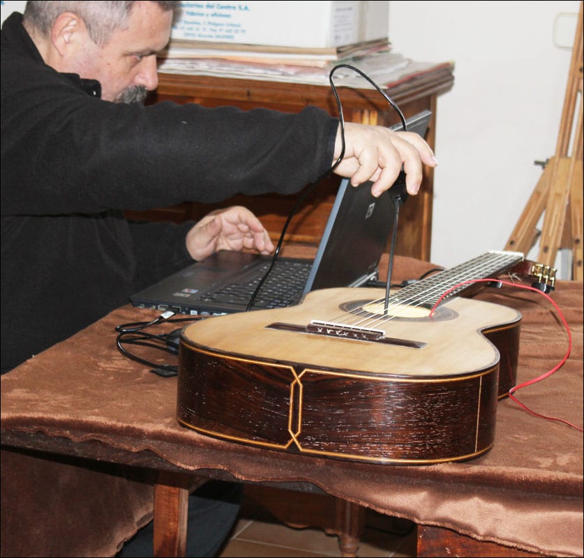 Josep Melo examines “Rosa,” the guitar Jose made for his sister