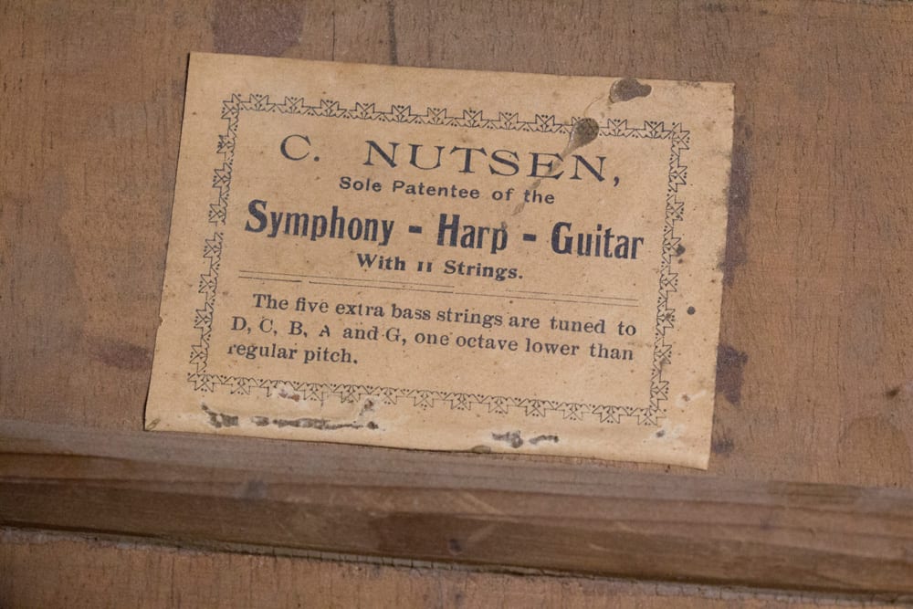 The label on the back which Kerry removed from the harp guitar.