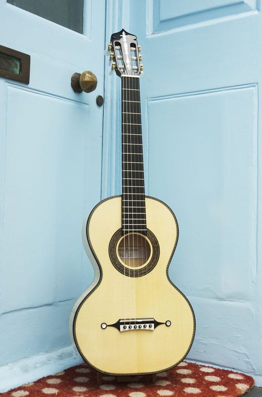 Salon guitar “in the French style.” Maple and spruce with pearl inlay and a mixed style bridge make for an attractive mix.