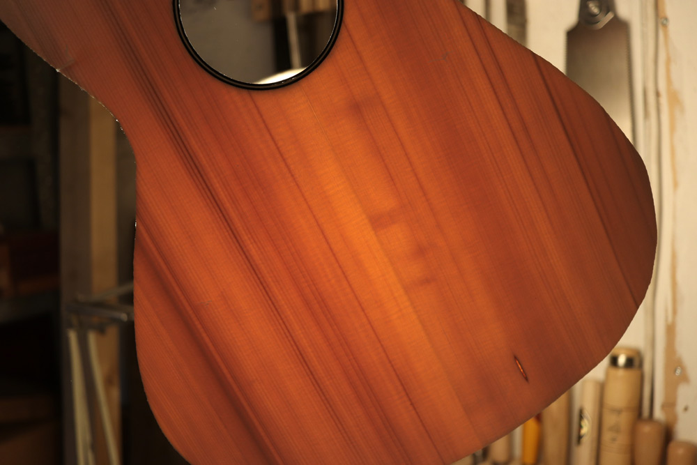 A spruce board with some compression wood and a pitch pocket, but still with very good tonal and structural qualities.