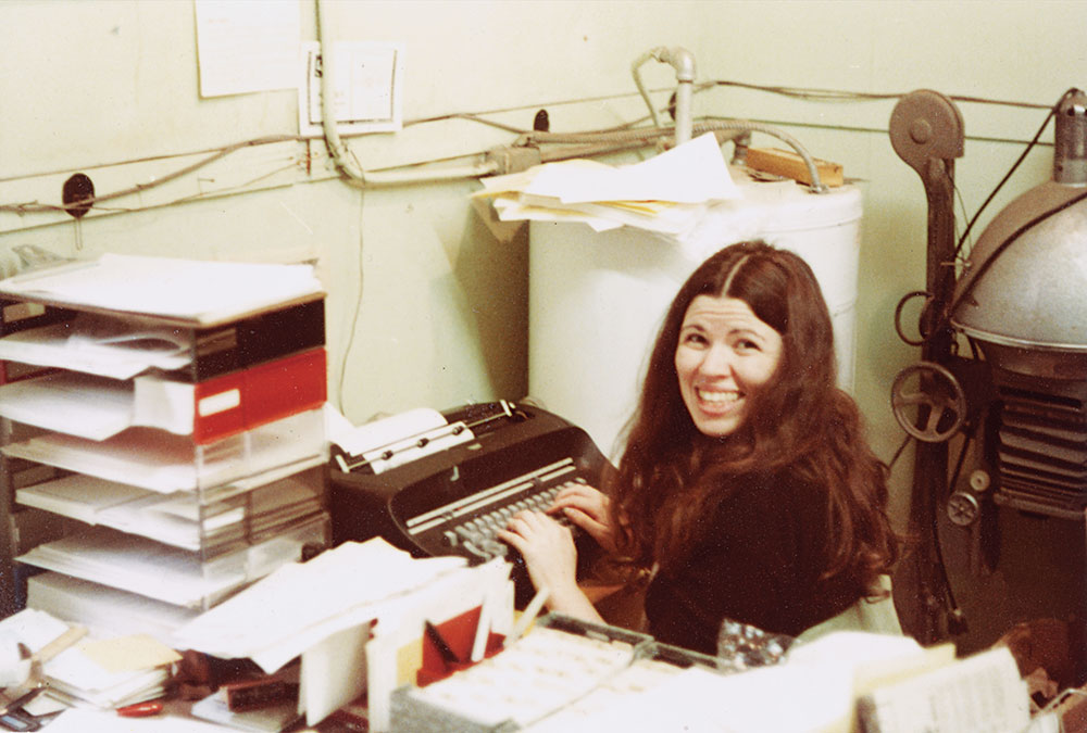 Bon “Flying Caps” Henderson in 1978, with our new IBM Selectric typewriter, which ended her ability to produce those flying caps!