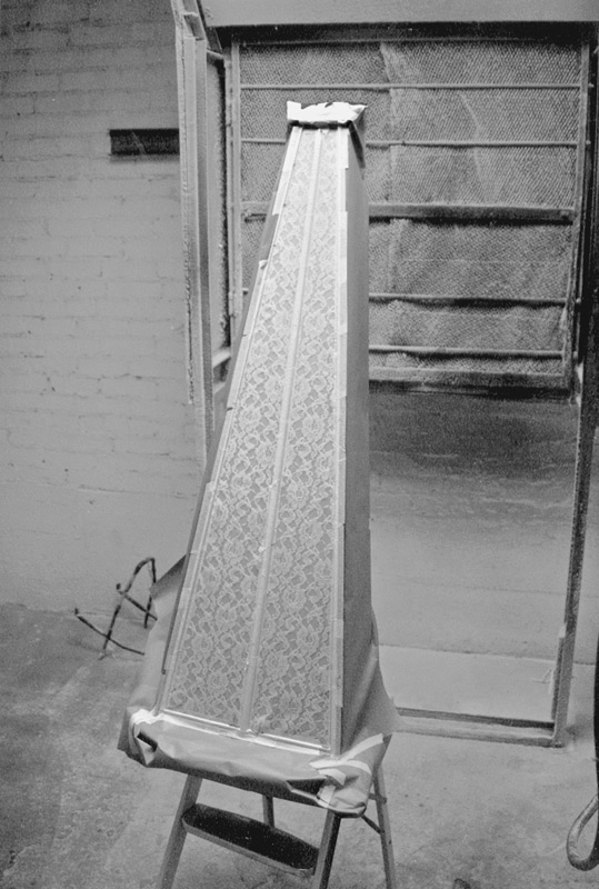The rest of the harp is masked off with paper and placed in the spray booth.