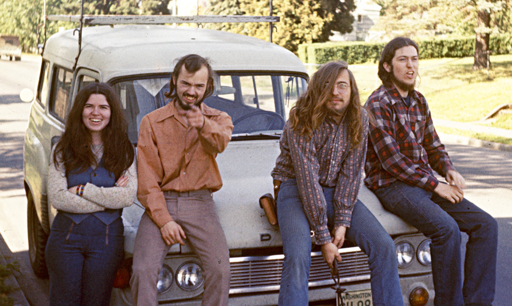 GAL staff members in 1975. From left: Bon Henderson, Leo Bidne, Bob Petrulis, and Tim Olsen. Deb Olsen was holding the camera. These hippies posed in front of our current GAL headquarters, which is the same building as Tim and Deb’s house. At that time it was the location of Tim’s lutherie shop, where Bob and Leo joined Tim in lutherie pursuits. (This photo was part of the slide show, The Making of a Newsletter, which was prepared in 1975 for the 2nd GAL Convention held in Evanston, Illinois, which Leo attended with Tim and Deb.) Both photos by Deb Olsen.